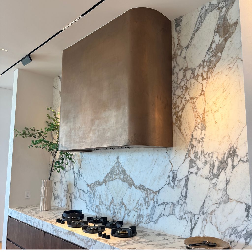 Handcrafted metallic kitchen hood finish by California Wall Design