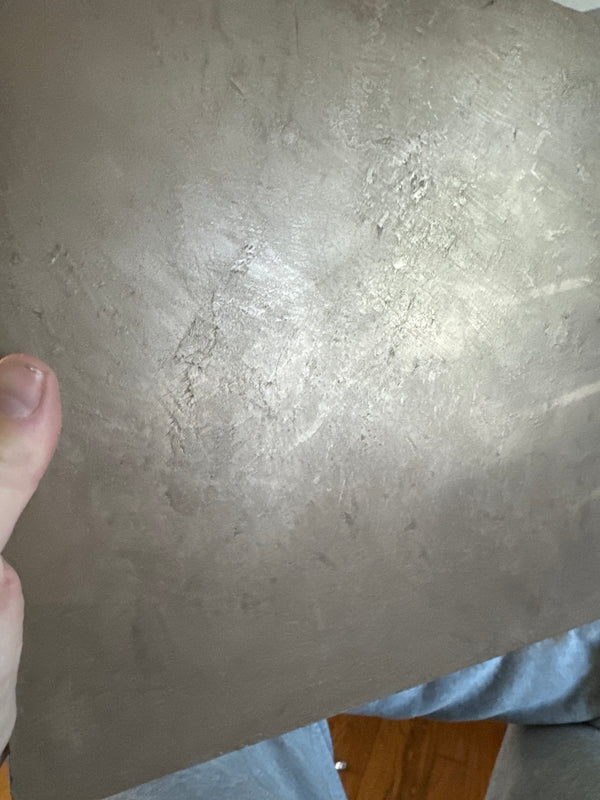 Close-up of a metallic plaster texture sample
